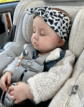 Baby girl is wearing a soft baby headband for little girls from By Bella Boutique.